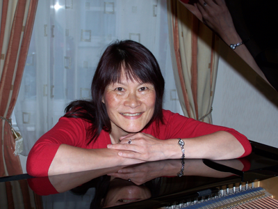 Loc-Mai on smiling on Kawai grand piano